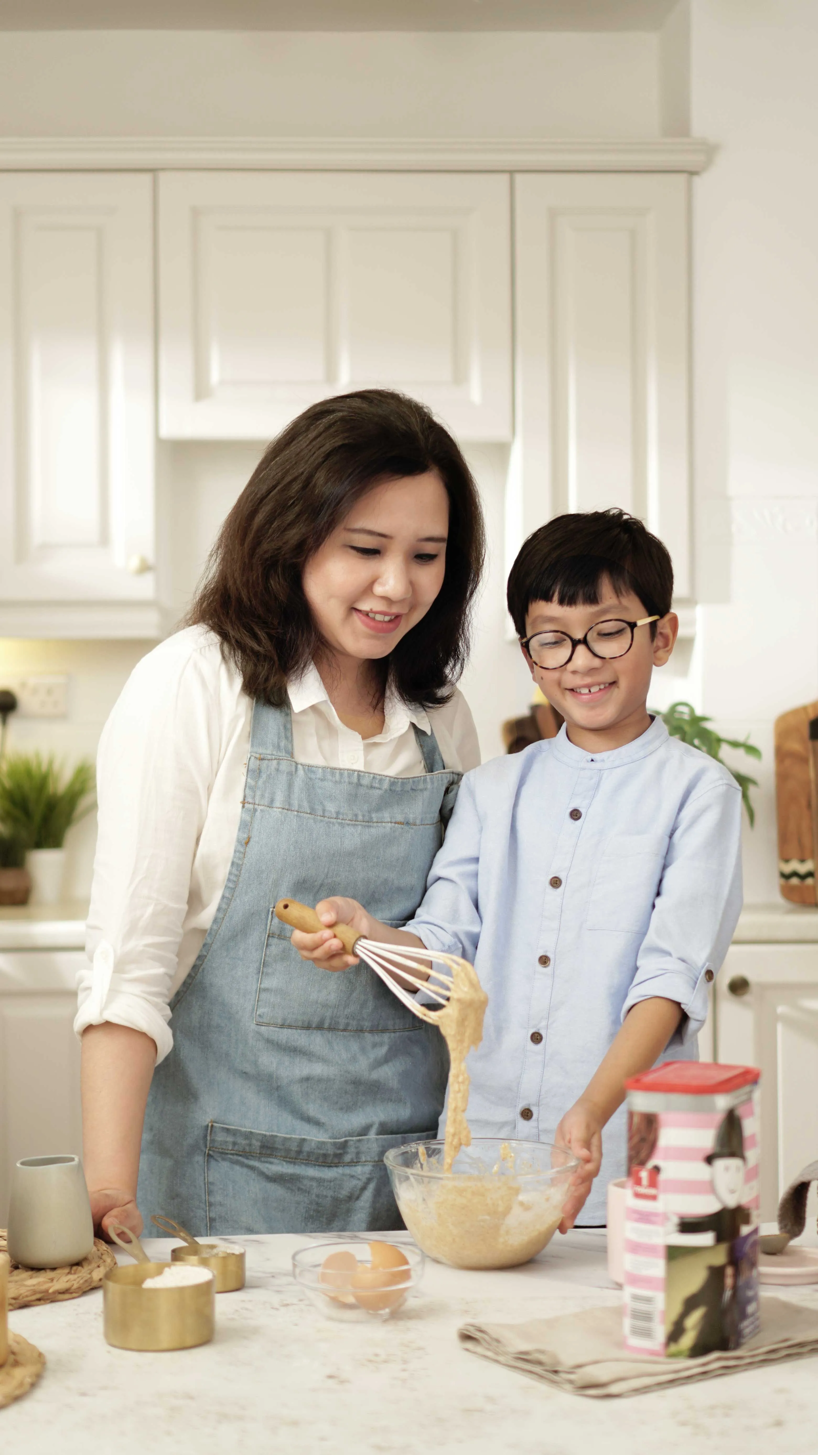 Khin in the kitchen with her son.